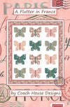 Cover page of a butterfly themed lap quilt pattern in pastel pinks and greens design on a white background, titled 'A Flutter in France' by Coach House Designs