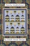 Front cover of lap quilt pattern that has 8 quaint houses sitting on lines of green grass with lollipop like tree blocks, half of which have blue hearts in them. The remaining trees have a floral pattern. The houses and trees are set on a blue background with a darker blue border. The quilt patterns is titled 'Family Neighborhood' by Coach House Designs.