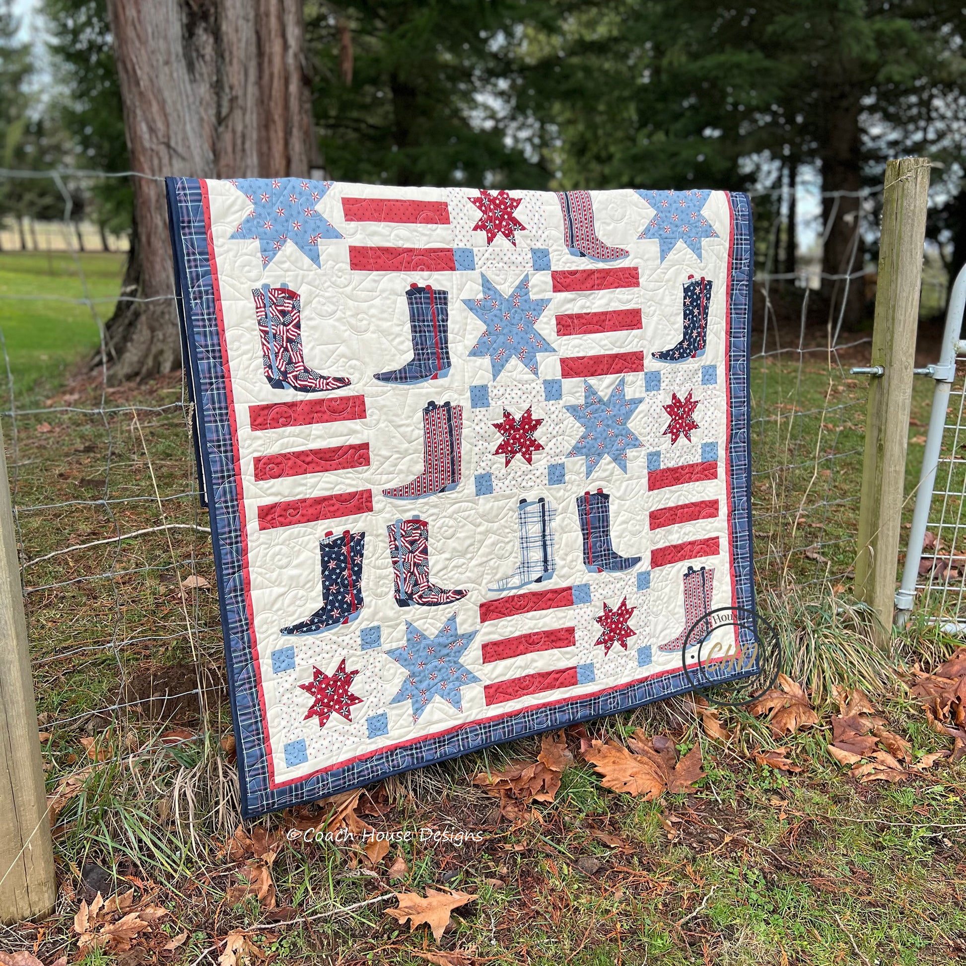 Americana Lap Quilt with American flag and boot patterns displayed outdoors designed by Coach House Designs featuring America 250 Years fabric by Deb Strain.