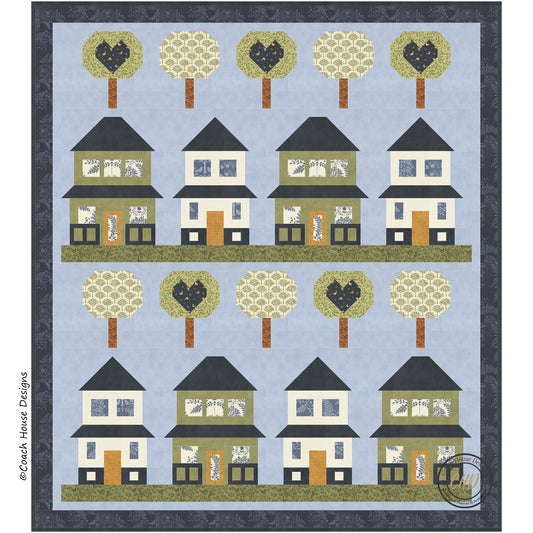 Digital close-up of the lap quilt motif, consisting of 8 quaint green and cream  houses sitting on lines of green grass with lollipop like tree blocks, half of which have blue hearts in them. The remaining trees have a floral pattern. The houses and trees are set on a blue background with a darker blue border.
