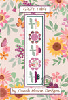 Table runner quilt pattern featuring bold floral shapes in floral fabric on a white background, titled 'GiGi's Table' by 'Coach House Designs'.